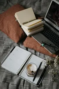 Portatile con un quaderno e un caffè